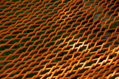 Close view of the hand-woven Orange soft-spun polyester rope weave of the Jumbo Rope Hammock.