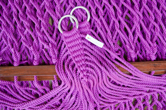 Close view of the gathered Purple end cords and O-rings of the Jumbo Rope Hammock above the wood spreader bar.