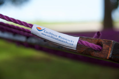 Caribbean Hammocks brand label on the wood spreader bar of the Purple Jumbo Rope Hammock.