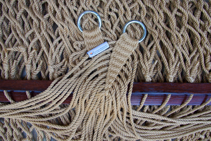 Close view of the gathered Tan end cords and O-rings of the Jumbo Rope Hammock above the wood spreader bar.