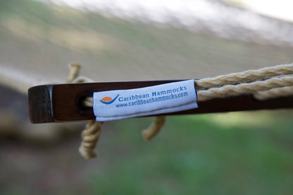 Caribbean Hammocks brand label on the wood spreader bar of the Tan Jumbo Rope Hammock.
