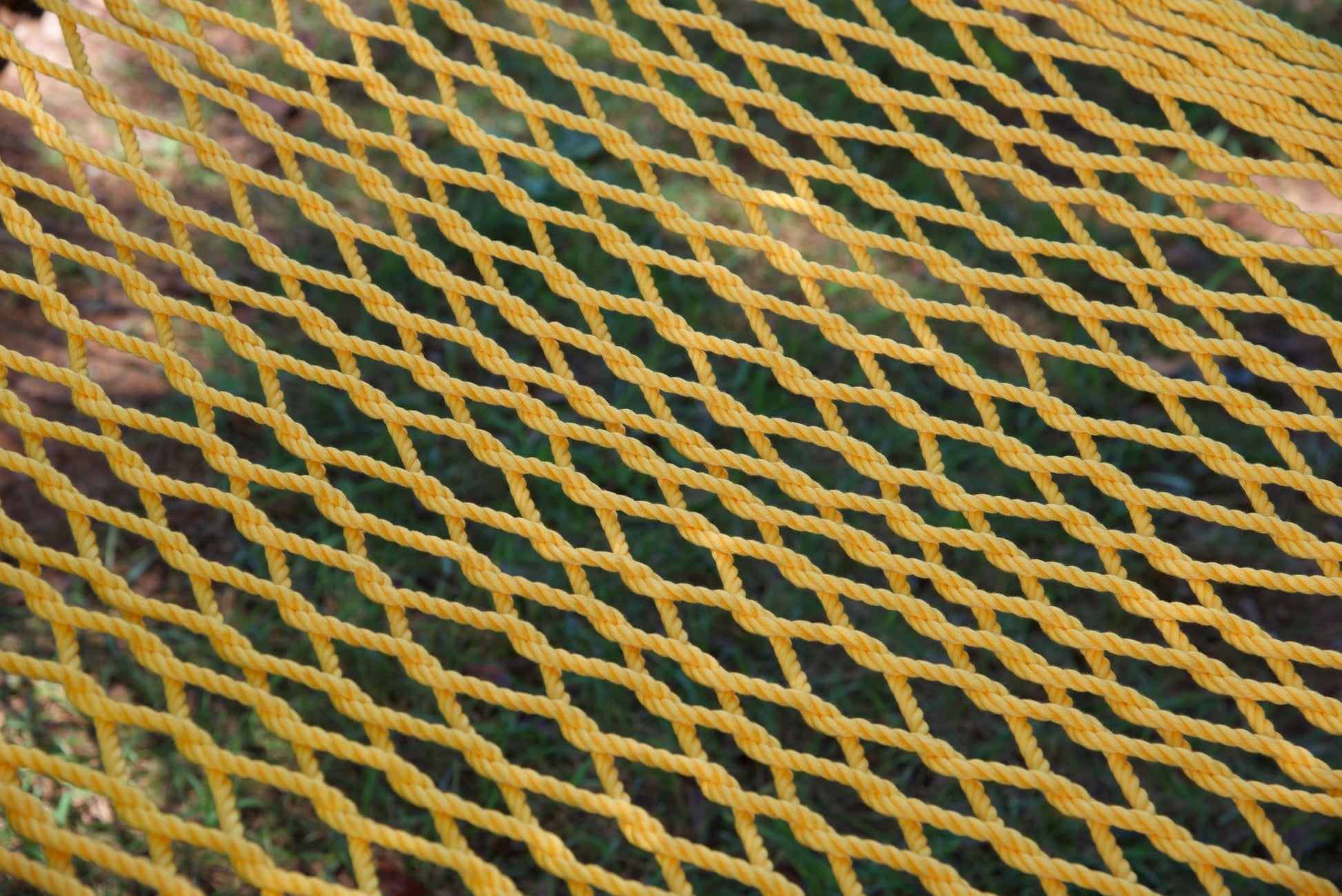 Close view of the hand-woven Yellow soft-spun polyester rope weave of the Jumbo Rope Hammock.