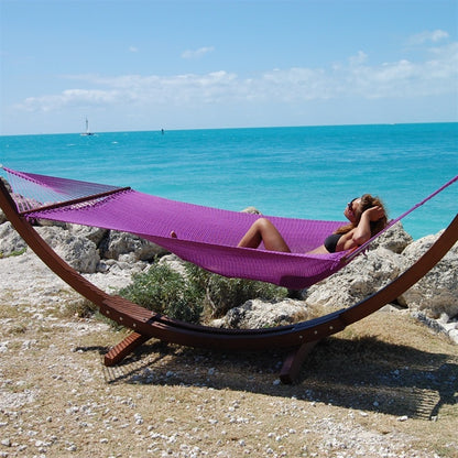 Woman laying in Jumbo Purple Hammock with Wooden Hammock Stand