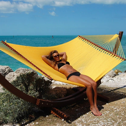 Woman laying in Jumbo Yellow Hammock with Wooden Hammock Stand