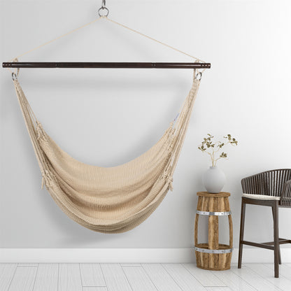 Cream Jumbo Caribbean Hammock Chair hanging beside a barrel side table and rattan stool against a pale grey wall