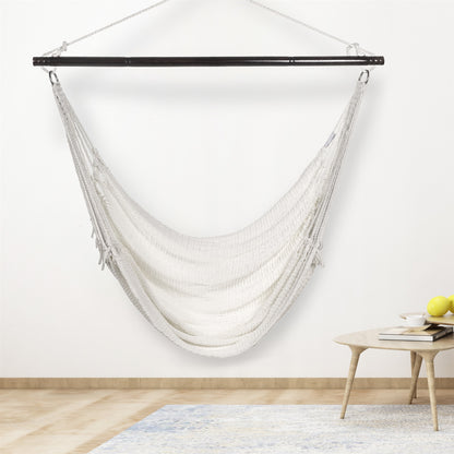 White Jumbo Caribbean Hammock Chair hanging indoors beside a small round side table against a cream wall