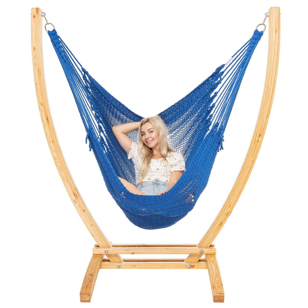 Dark Blue Jumbo Caribbean Recliner on a Siberian larch wood arc stand, woman leaning back with arms behind the head