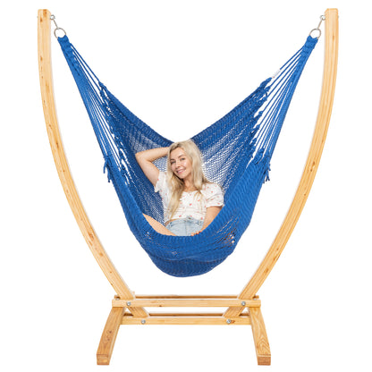 Dark Blue Jumbo Caribbean Recliner on a Siberian larch wood arc stand, woman leaning back with arms behind the head