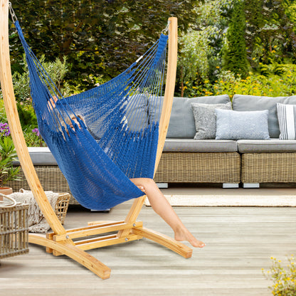 Dark Blue Jumbo Caribbean Recliner on a wood arc stand on a deck beside a wicker sofa