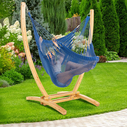 Dark Blue Jumbo Caribbean Recliner on a wood arc stand in a backyard beside flowering hydrangeas