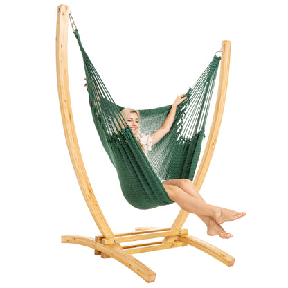 Green Jumbo Caribbean Recliner on a Siberian larch wood arc stand, woman seated, three-quarter view