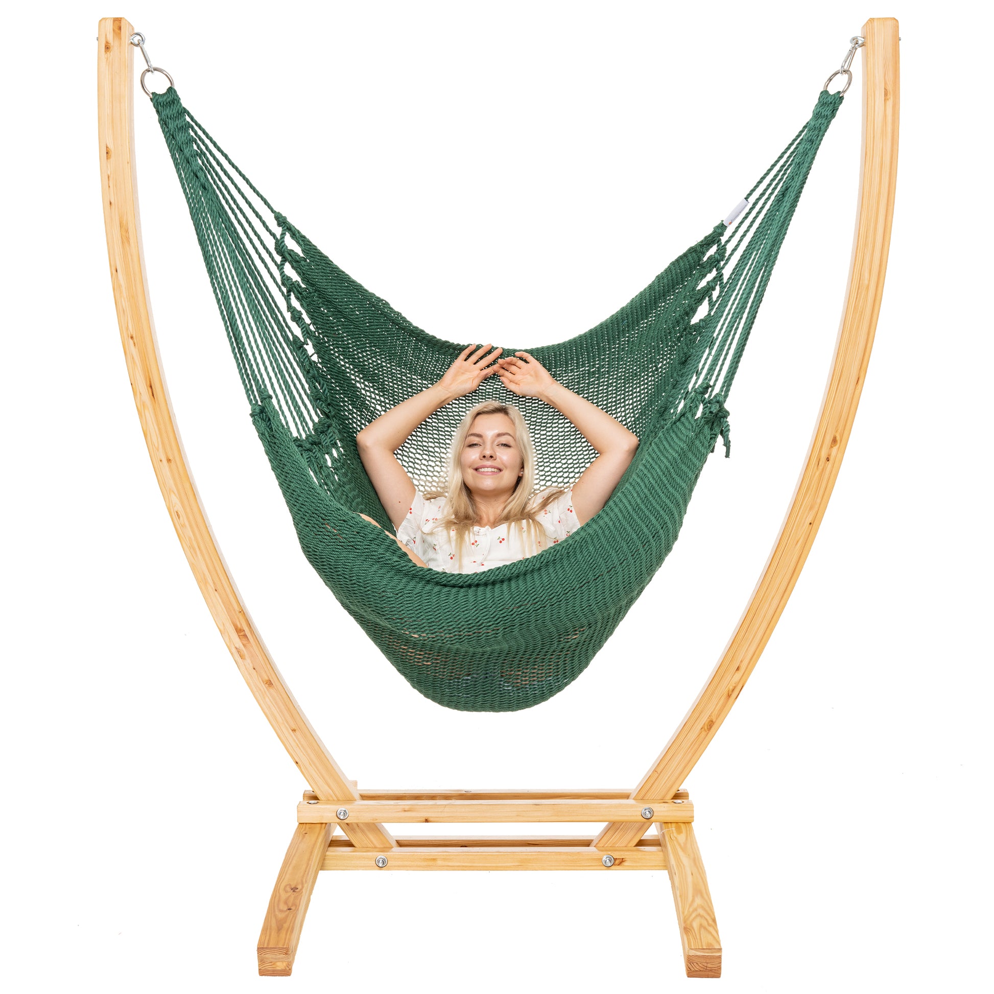 Green Jumbo Caribbean Recliner on a Siberian larch wood arc stand, woman leaning back with arms behind the head