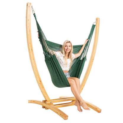 Green Jumbo Caribbean Recliner on a Siberian larch wood arc stand, woman seated upright, side view