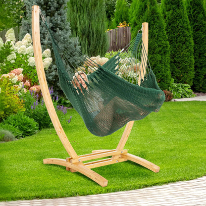 Green Jumbo Caribbean Recliner on a wood arc stand in a backyard beside flowering hydrangeas