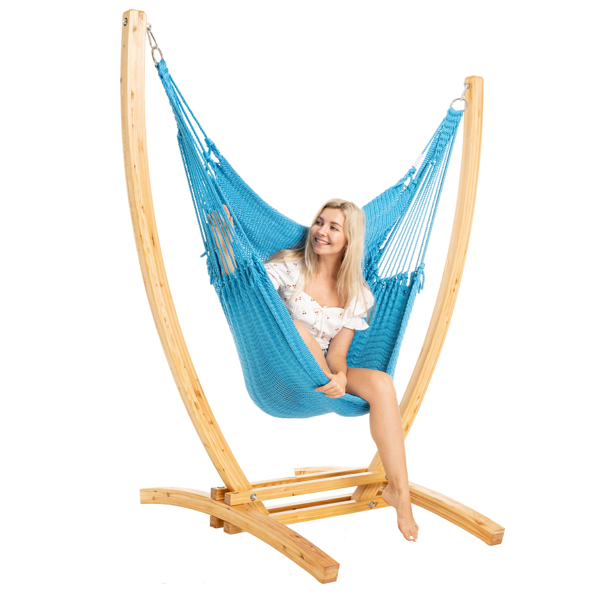 Light Blue Jumbo Caribbean Recliner on a Siberian larch wood arc stand, woman seated, three-quarter view