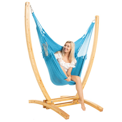 Light Blue Jumbo Caribbean Recliner on a Siberian larch wood arc stand, woman seated, three-quarter view
