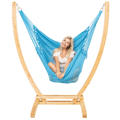 Light Blue Jumbo Caribbean Recliner on a Siberian larch wood arc stand, woman seated upright, front view