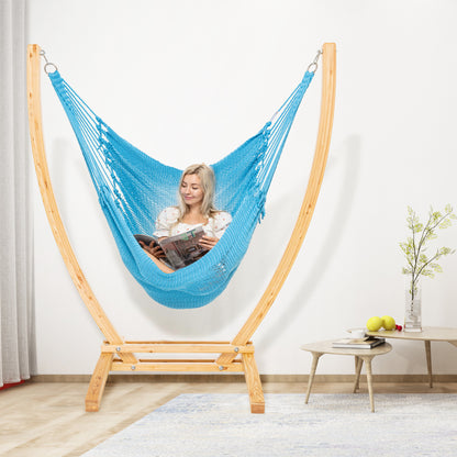 Light Blue Jumbo Caribbean Recliner on a wood arc stand in a living room beside a low round side table