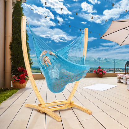 Light Blue Jumbo Caribbean Recliner on a wood arc stand on a rooftop deck under string lights and a patio umbrella