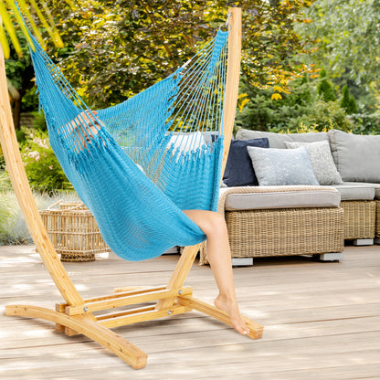 Light Blue Jumbo Caribbean Recliner on a wood arc stand on a deck beside a wicker sofa