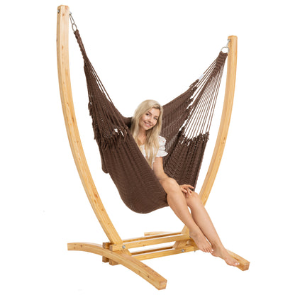 Mocha Jumbo Caribbean Recliner on a Siberian larch wood arc stand, woman seated, three-quarter view