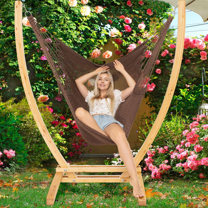 Mocha Jumbo Caribbean Recliner on a wood arc stand in a garden framed by climbing roses
