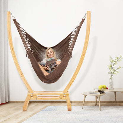 Mocha Jumbo Caribbean Recliner on a wood arc stand in a living room beside a low round side table