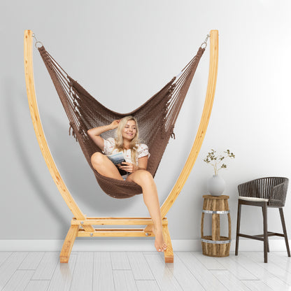 Mocha Jumbo Caribbean Recliner on a wood arc stand in a styled interior corner beside a woven barstool