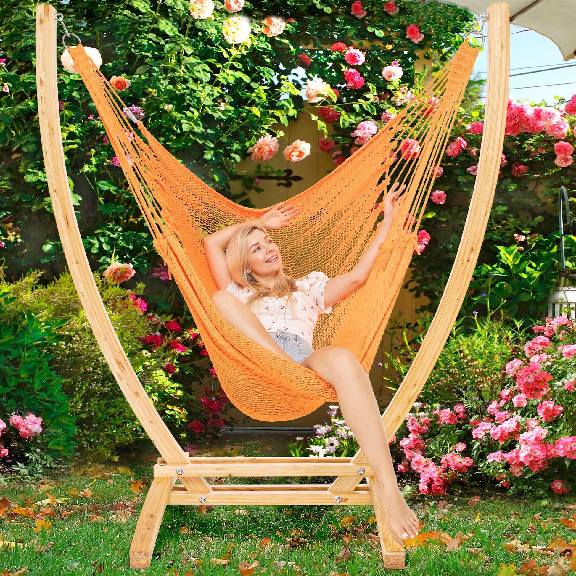 Orange Jumbo Caribbean Recliner on a wood arc stand in a garden framed by climbing roses