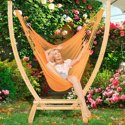 Orange Jumbo Caribbean Recliner on a wood arc stand in a garden framed by climbing roses