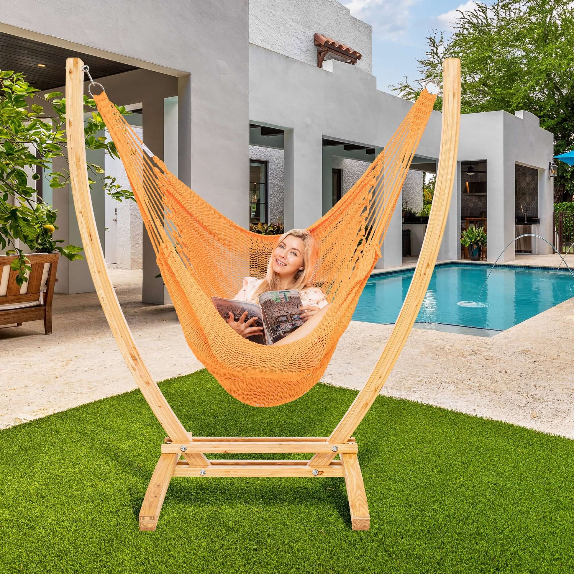 Orange Jumbo Caribbean Recliner on a wood arc stand beside a swimming pool