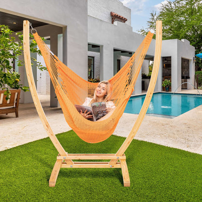 Orange Jumbo Caribbean Recliner on a wood arc stand beside a swimming pool