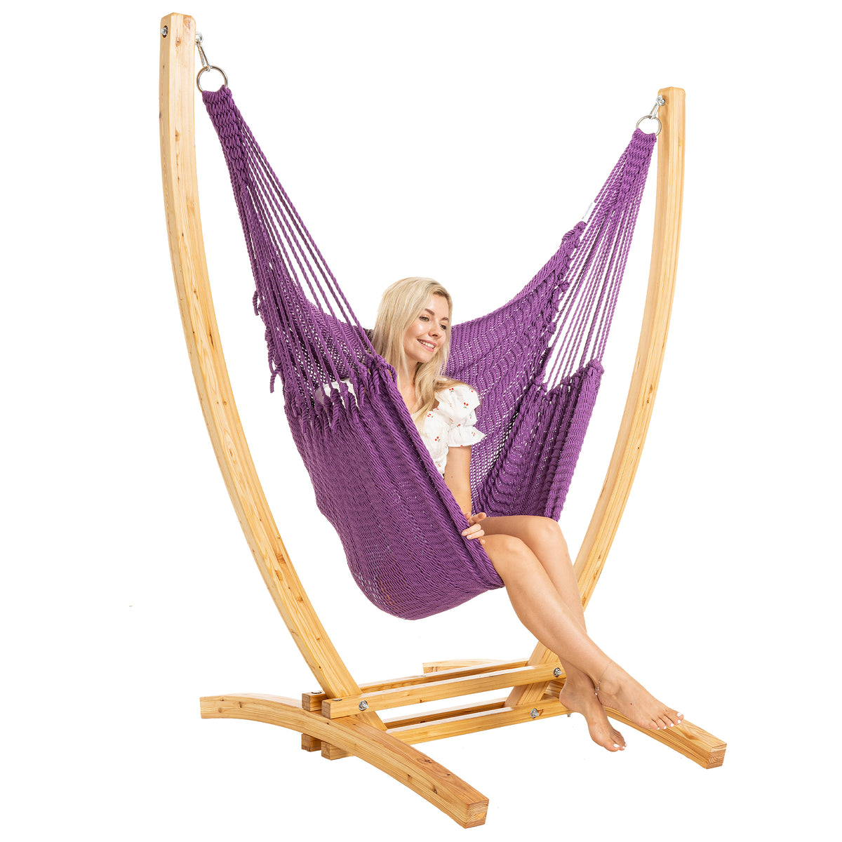 Purple Jumbo Caribbean Recliner on a Siberian larch wood arc stand, woman seated upright, three-quarter view