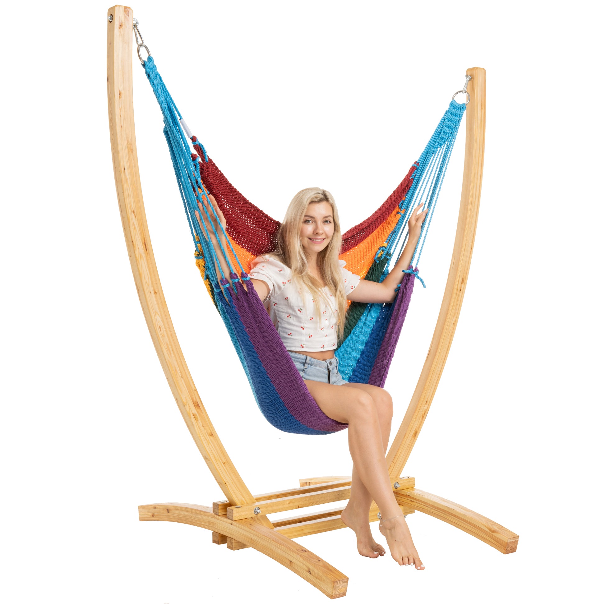 Rainbow Jumbo Caribbean Recliner on a Siberian larch wood arc stand, woman seated upright, side view