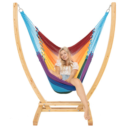 Rainbow Jumbo Caribbean Recliner on a Siberian larch wood arc stand, woman seated upright, front view