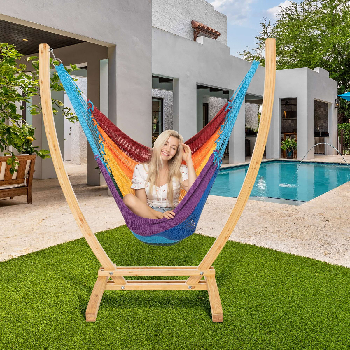 Rainbow Jumbo Caribbean Recliner on a wood arc stand beside a swimming pool