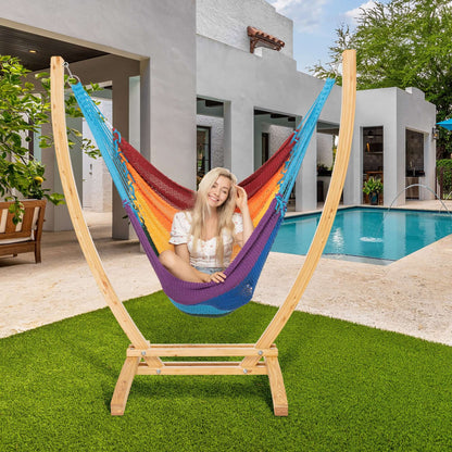 Rainbow Jumbo Caribbean Recliner on a wood arc stand beside a swimming pool