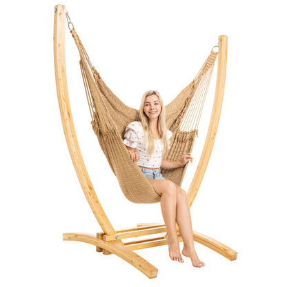 Tan Jumbo Caribbean Recliner on a Siberian larch wood arc stand, woman seated upright, front view