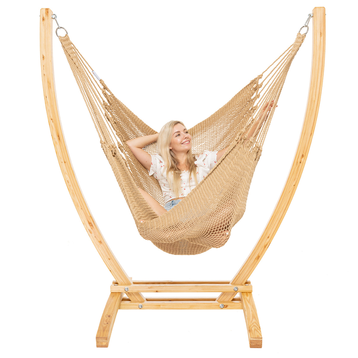 Tan Jumbo Caribbean Recliner on a Siberian larch wood arc stand, woman leaning back with arms behind the head