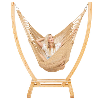 Tan Jumbo Caribbean Recliner on a Siberian larch wood arc stand, woman leaning back with arms behind the head