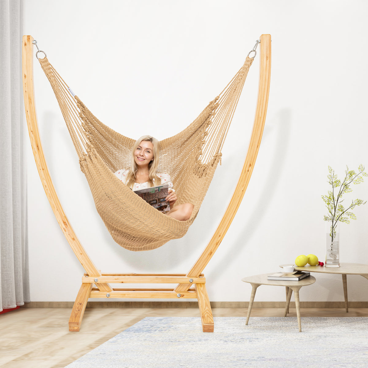 Tan Jumbo Caribbean Recliner on a wood arc stand in a living room beside a low round side table