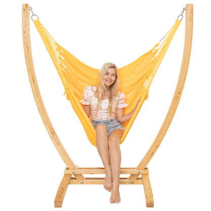 Yellow Jumbo Caribbean Recliner on a Siberian larch wood arc stand, woman seated upright, front view