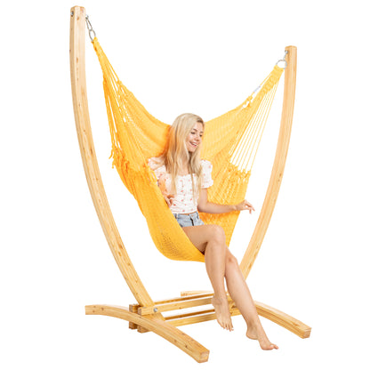 Yellow Jumbo Caribbean Recliner on a Siberian larch wood arc stand, woman seated with both hands on the end cords