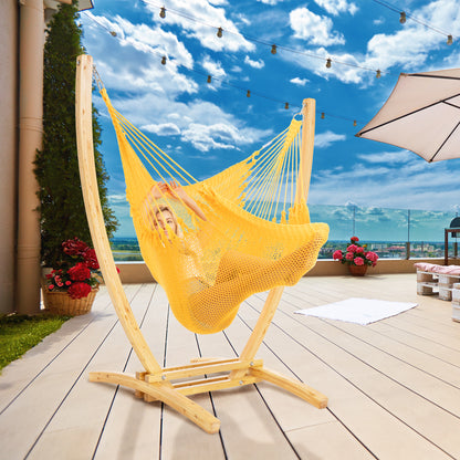 Yellow Jumbo Caribbean Recliner on a wood arc stand on a rooftop deck under string lights and a patio umbrella