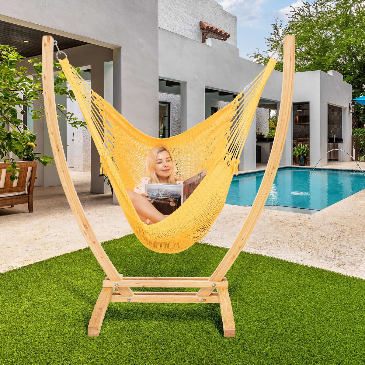 Yellow Jumbo Caribbean Recliner on a wood arc stand beside a swimming pool