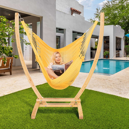 Yellow Jumbo Caribbean Recliner on a wood arc stand beside a swimming pool