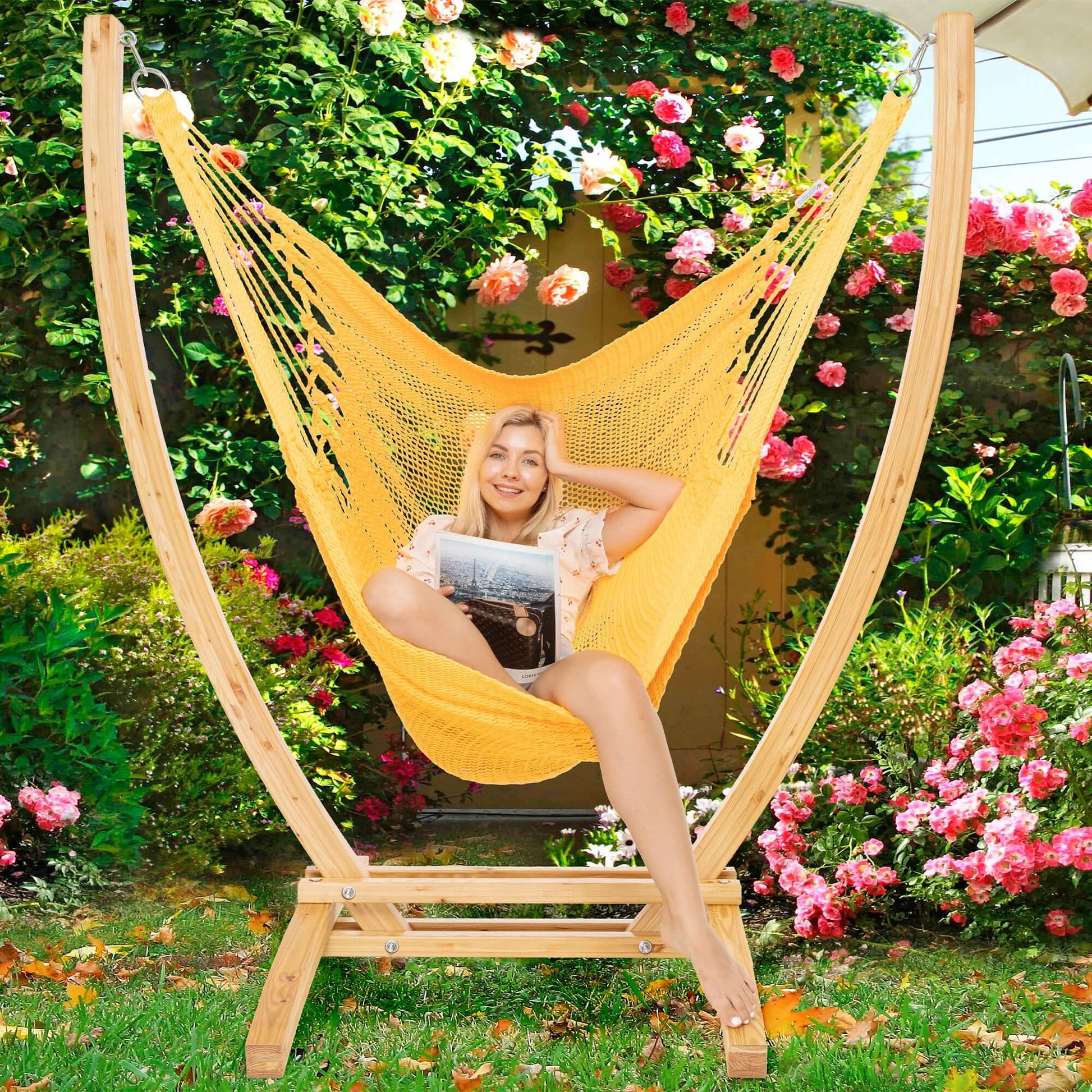 Yellow Jumbo Caribbean Recliner on a wood arc stand in a garden framed by climbing roses
