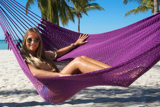 Close view of a woman in sunglasses reclining in the Purple Jumbo Mayan Hammock