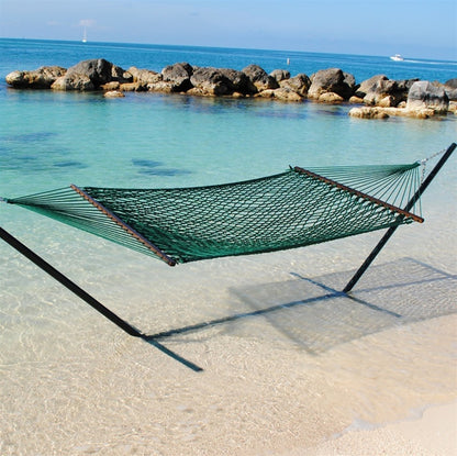 Green Jumbo Rope Hammock on a black Tri-Beam hammock stand at the water's edge.
