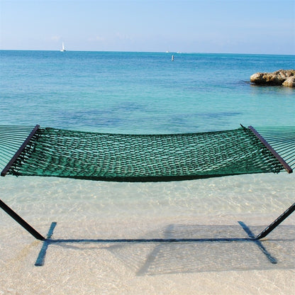 Green Jumbo Rope Hammock on a black Tri-Beam hammock stand at the water's edge.